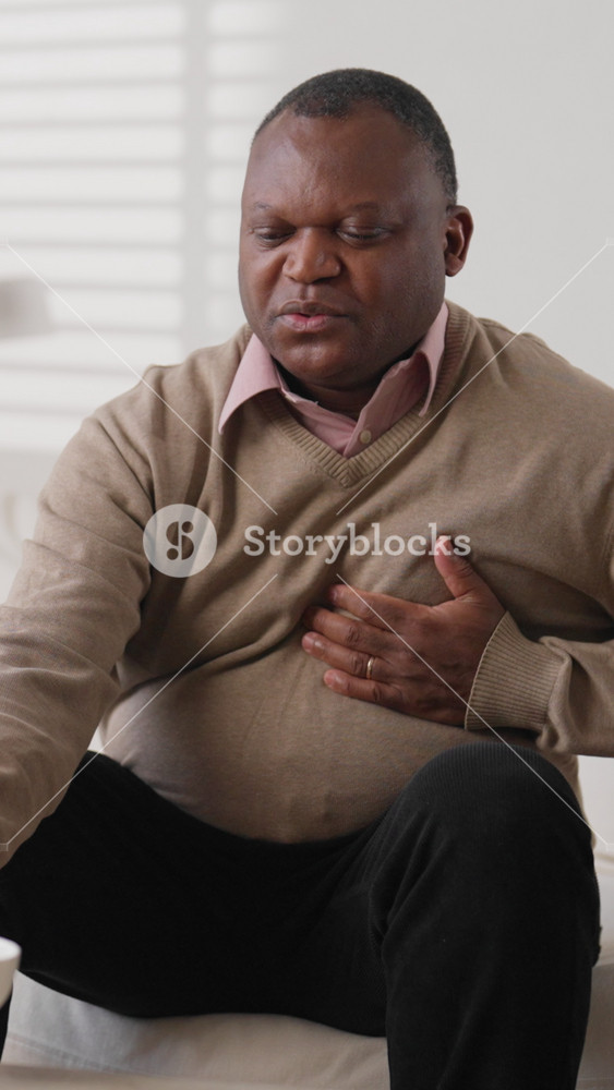 Mature overweight black man feeling ache in chest, heart attack and attack of pain. Healthcare and medicine, senior african american male