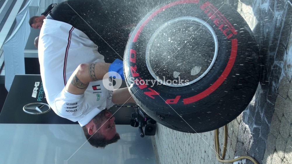 SOCHI, RUSSIA - 29 September 2019: Mercedes F1 team mechanic wash slick tyre Vertical cinematic Footage from Formula 1 Grand Prix of Russia
