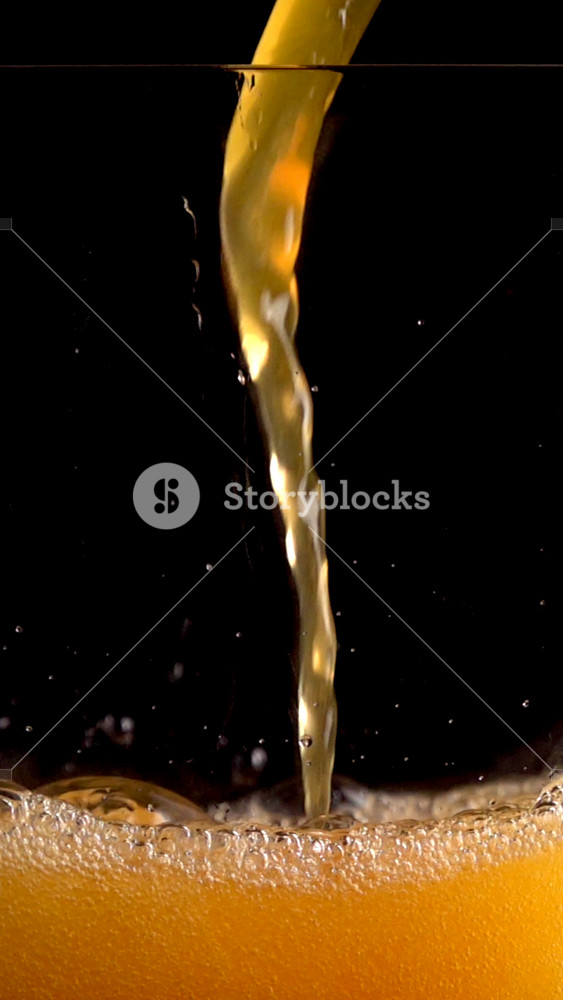 Watch Fanta Cocktail With Orange Juice and Soda Poured in a Glass in Super Slow Motion at 1000 Fps With Foam and Bubbles