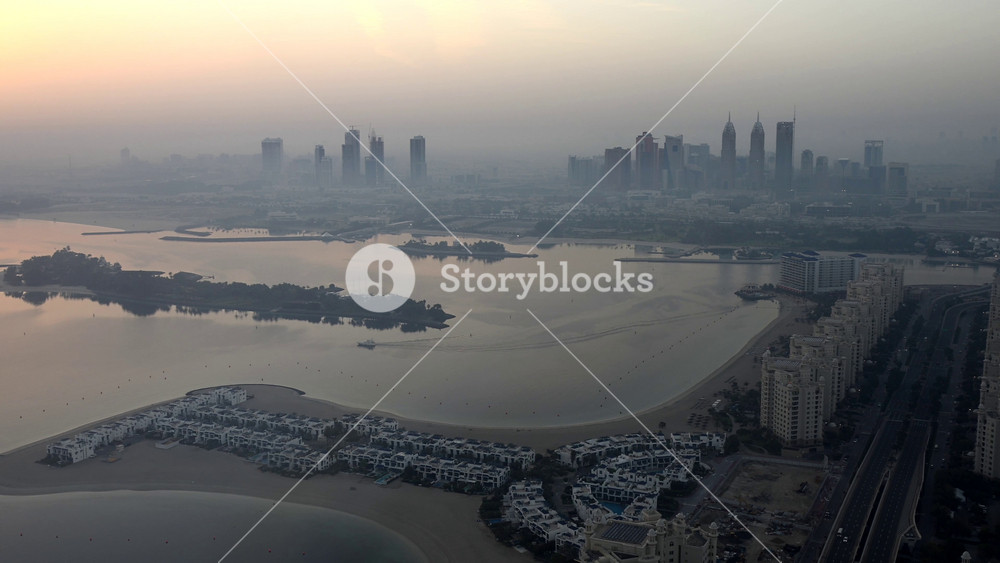 Explore the vast expanse of water from an aerial perspective at sunrise in Dubai, UAE. Experience the beauty of the serene waters from above