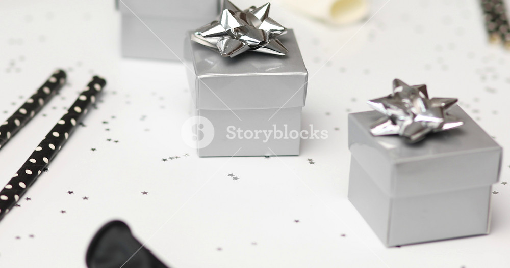 Rotation of festival birthday party background with black and silver gift box various party, balloons, decorations on a white background, Happy Birthday party concept