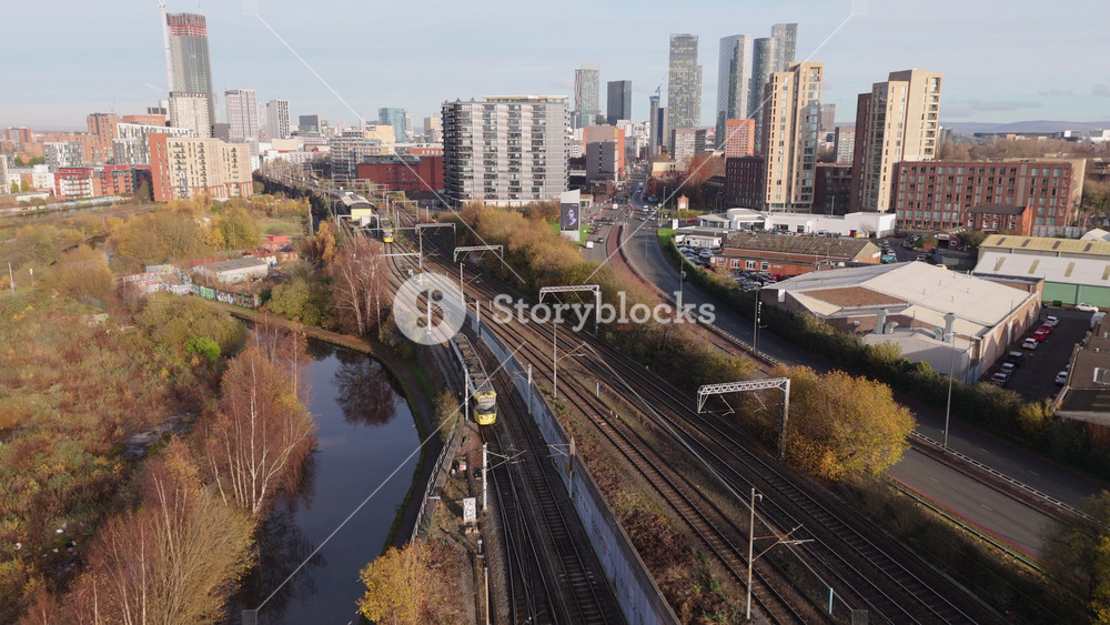 Manchester, England - November 28, 2024: Aerial view of trams in Manchester, United Kingdom going along track. Public transportation concept