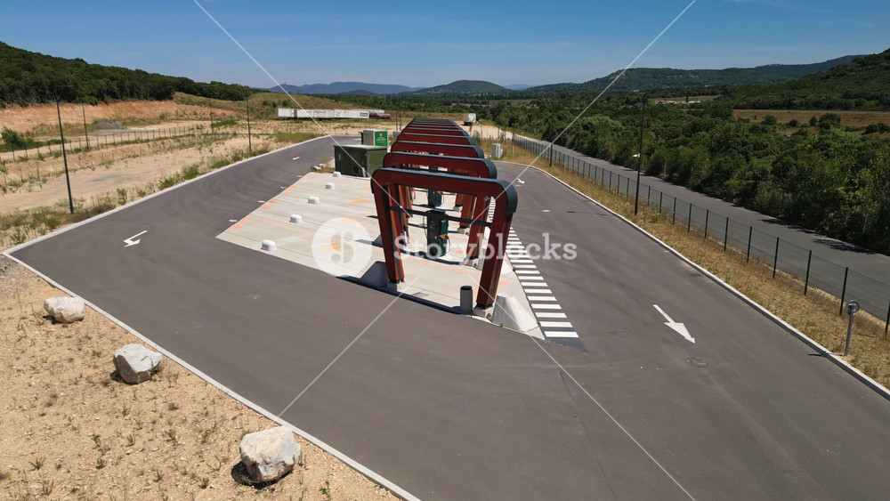 Aerial drone view of the Milence electric truck charging hub with ultra-fast charging bays for heavy-duty electric vehicles on the A7 motorway in Southern France