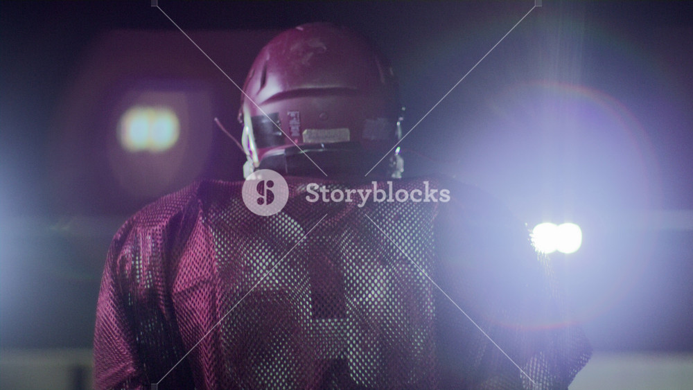 Football Stadium Tunnel: Successful Athletic American Football Player Walking Out to the Field Before a Championship Match. Excited Crowd of