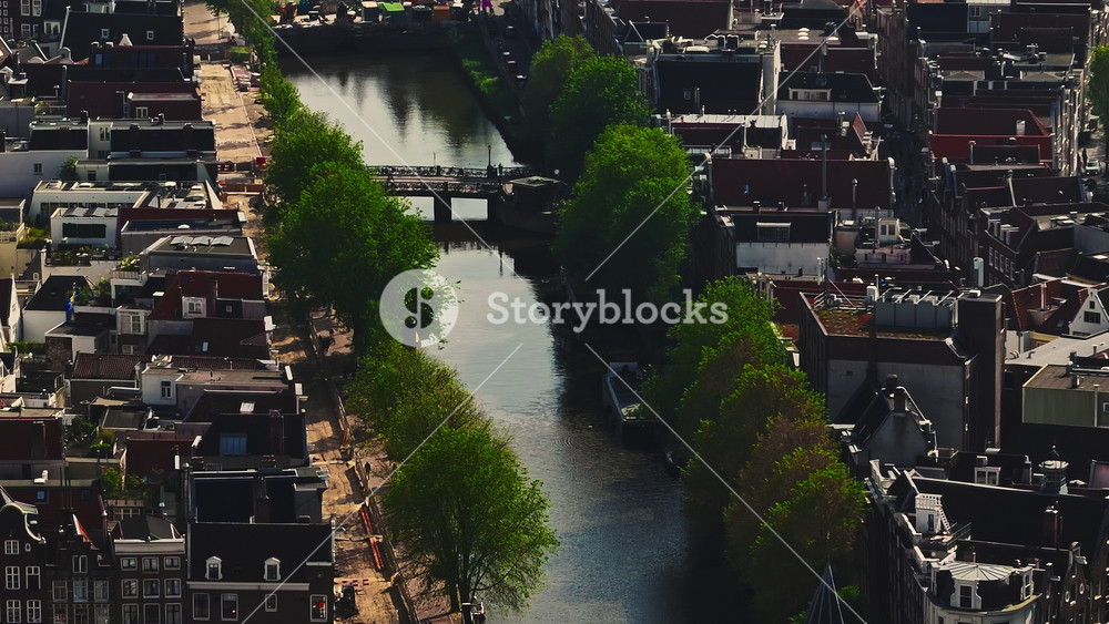 Aerial view of Amsterdam city, Netherlands. Aerial view of canals with boats in the center city. Cityscape narrow old houses, canals, old