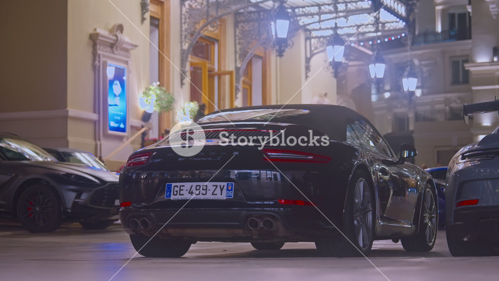 Monaco, Monte-Carlo, 05 February 2025: Luxury cars porsche, attraction night illumination. Sports cars drive through the central square