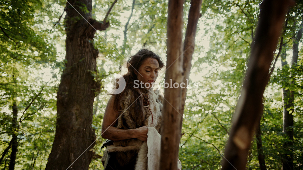 Prehistoric Cave Woman Handles Animal Skins, Furs and Hides. Primitive Neanderthal Woman Lifestyle Surviving, Doing Cave Chores and Household Work
