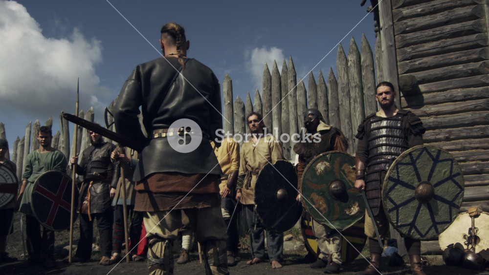 Dressed in Medieval Clothing Group of People Rising Swords. Life of Civilian People at the Village. Medieval Reenactment.
