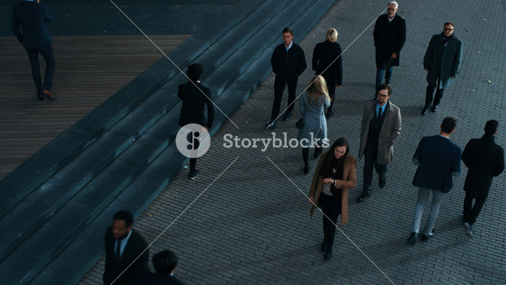 High Angle Shot of Office Managers and Business People Commuting to Work in the Morning or from Office in the Evening on Foot. Pedestrians are Dressed Smartly. Successful People Holding Smartphones.
