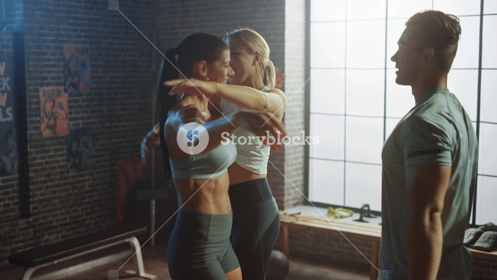 Portrait of Super Happy Team of Two Girls and one Boy Jumping, Dancing and Celebrating Great Success in Training, Exercise, Workout, Weight, Strenght, Muscle and Body Fat Goal Results in Gym