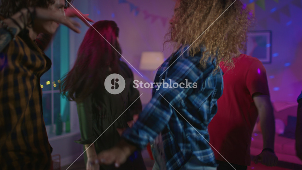 At the Wild House Party: Beautiful Black Girl Dances in Neon Light. In the Background Other Teenagers Having Fun, Clubbing.
