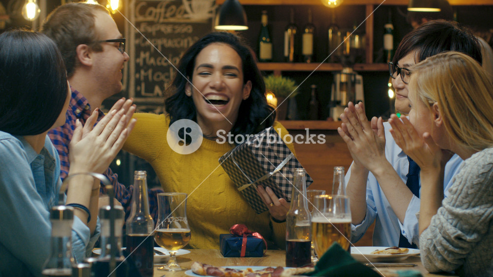 In the Bar/ Restaurant Beautiful Hispanic Woman Receives Gifts and Congratulations From Her Best Friends. Everybody is Happy!