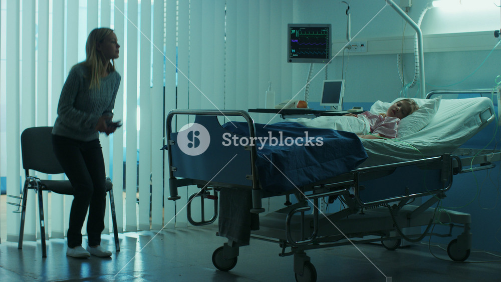 Sick Little Child Lying in the Hospital Bed Sleeping, Her Mother Worries Sits on a Chair Beside, Hoping fore the Best. Dramatic Family Moment.