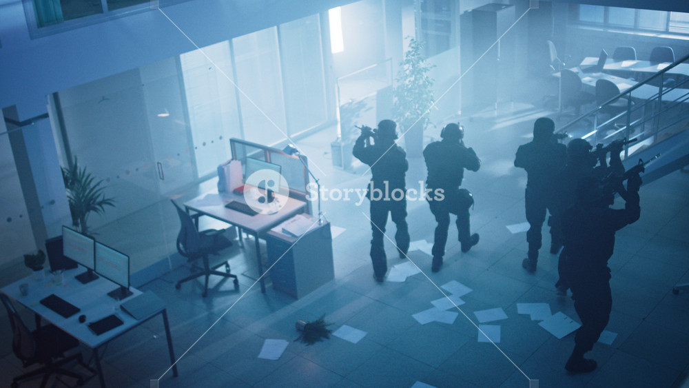 Masked Team of Armed SWAT Police Officers Slowly Move in a Hall of a Dark Seized Office Building with Desks and Computers. Soldiers with Rifles and Flashlights Surveil and Cover Surroundings. Above View.