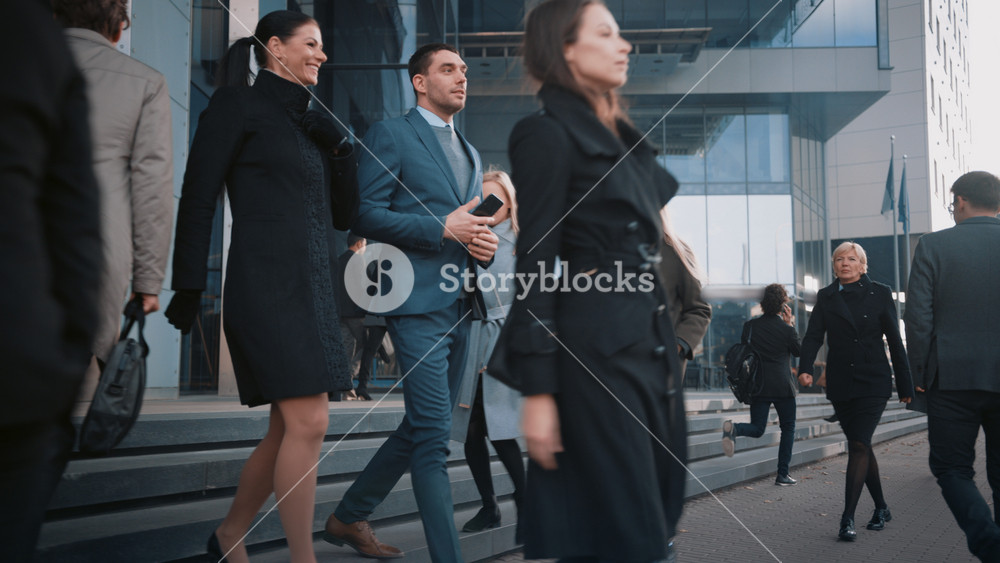 Diverse and Multicultural Office Managers and Business People Commute to Work in the Morning or from Office on a Sunny Day on Foot. Female and Male are Talking and Smiling on Their Way from Office.