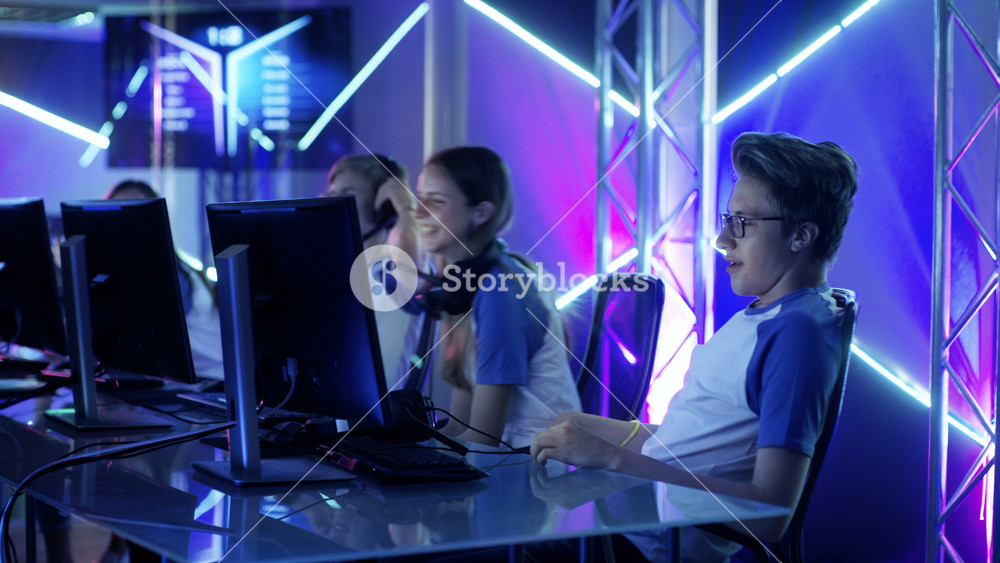 Team of Professional eSport Gamers Playing in Competitive Video Games on a Cyber Games Tournament. Team Wins, Spectators Applaud.