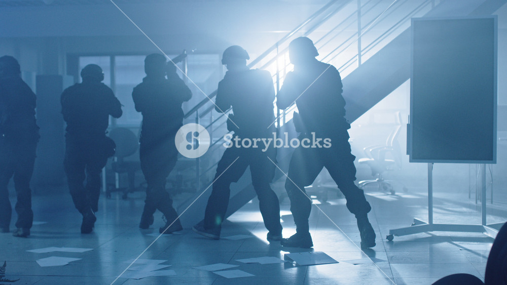 Close Up Portraits of Masked Squad of Armed SWAT Police Officers Storm a Dark Seized Office Building with Desks and Computers. Soldiers with Rifles and Flashlights Move Forward and Cover Surroundings.
