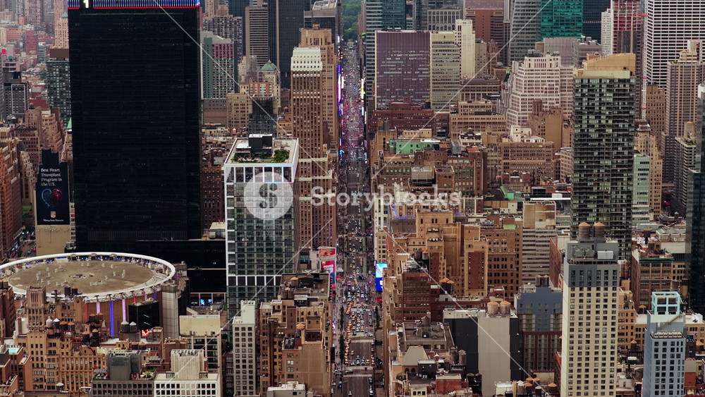 Aerial view of New York City's bustling Manhattan, highlighting iconic landmarks like Times Square and Radio City Music Hall