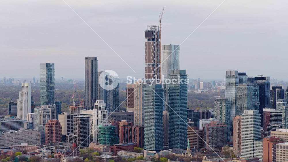 Aerial survey flying over Bloor Yorkville neighborhood revealing Toronto's urban cityscape, including residential condominium, apartment