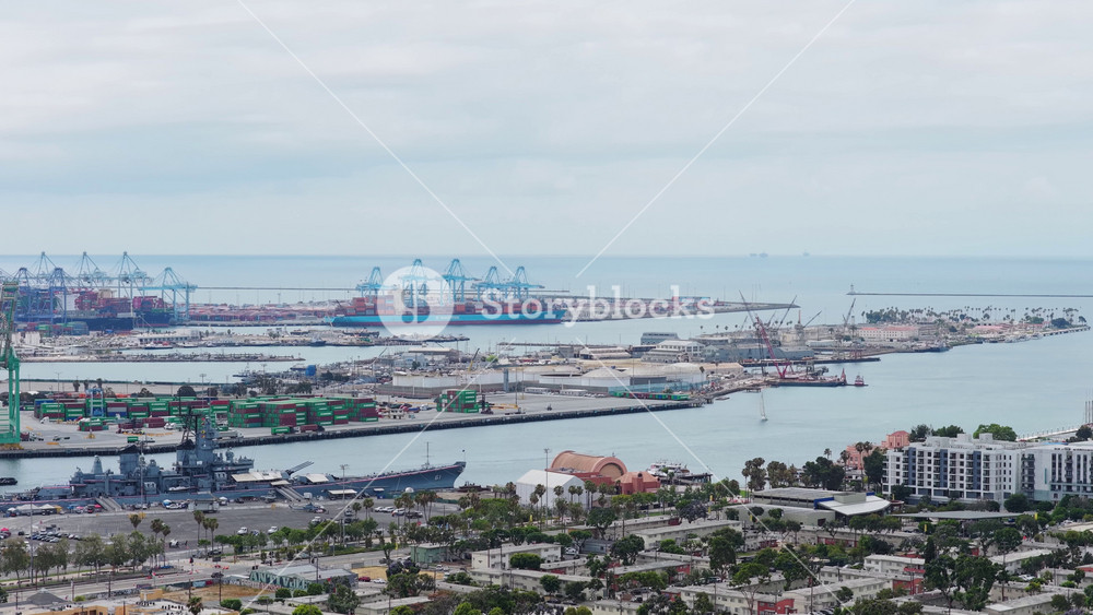 Battleship USS Iowa museum at Port of Los Angeles with container ships, cargo cranes, shipping terminals, San Pedro neighborhood overlooking