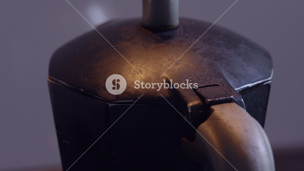 Close up of vintage stovetop moka pot with worn metal surface and textured lid, classic Italian espresso maker detail for home kitchen and coffee culture themes