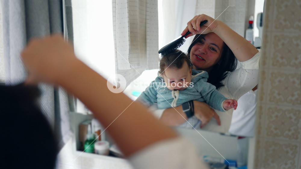 Mother holding baby close in bathroom mirror, sibling peeking in, family bonding, morning routine, family time, caregiving, warm moment, parent-child relationship, togetherness