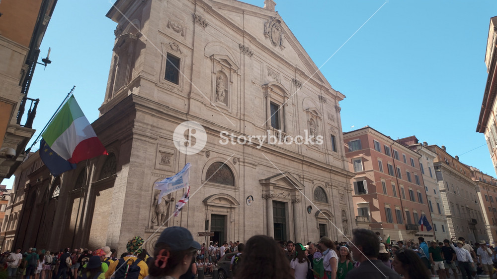 Rome Italy July 30th 2025 Exterior Of Church Of Saint Ignatius Of Loyola In Rome With Statues Italian And European Flags And Crowded Street Under Clear Sky