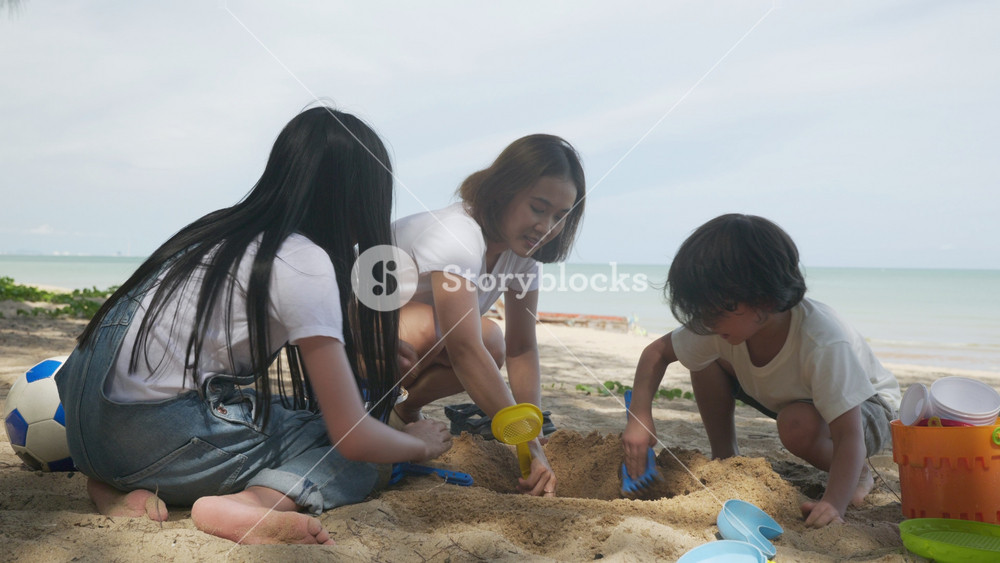 Happy family beach travel vacation for kid child enjoying summer trip, woman and children build sandcastles, playing