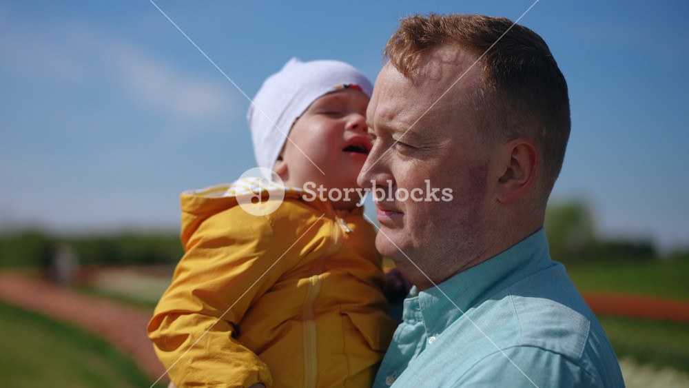 A truly heartwarming family scene depicting a loving father and his child happily enjoying the beauty of the outdoors