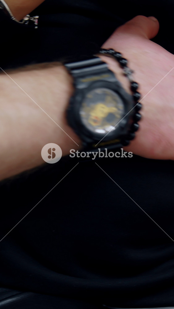 Male hand with a black wristwatch strokes pregnant lady's belly. Cropped image of a couple expecting a baby soon. Close up.. Vertical video