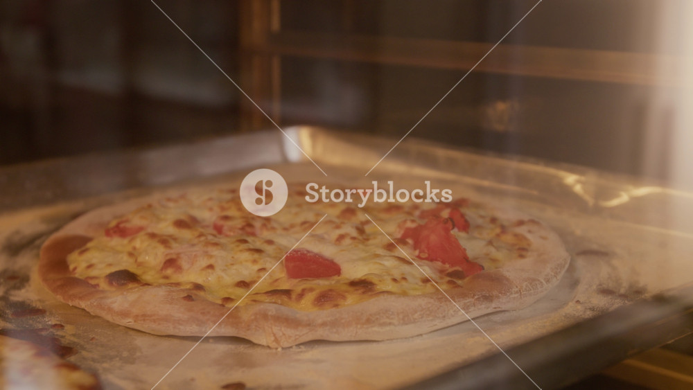 No people close up shot of pizza baking inside professional oven with cheese melting and bubbling on crust. Perfect for pizzeria advertisements, Italian restaurant promos, food delivery campaigns