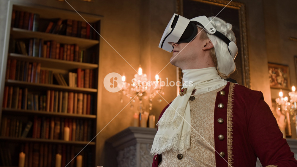 Medium close-up of actor in historical gentleman costume and VR headset standing on movie set in royal palace, exploring augmented reality of Victorian period lifestyle