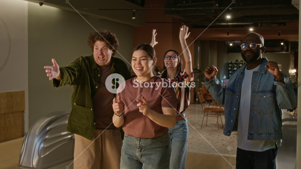 Asian woman throwing ball while diverse young gen Z friends cheer in team support in bowling alley. Ideal for youth lifestyle, entertainment venue ads, and social diversity campaigns