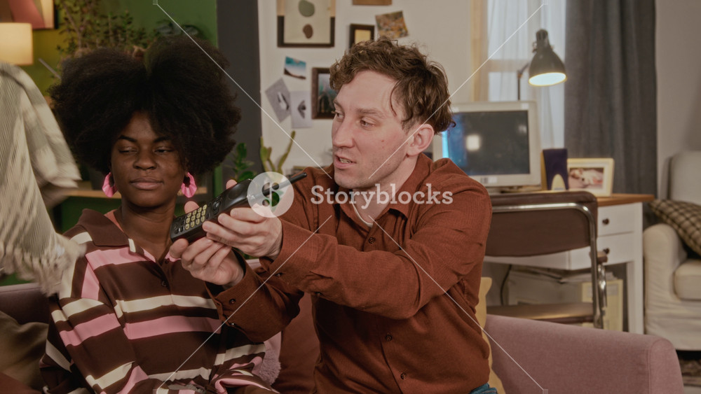 African American woman and Caucasian men sitting on couch, playing with retro walkie-talkie. Ideal for home entertainment, streaming service, or telecommunication brand marketing campaigns