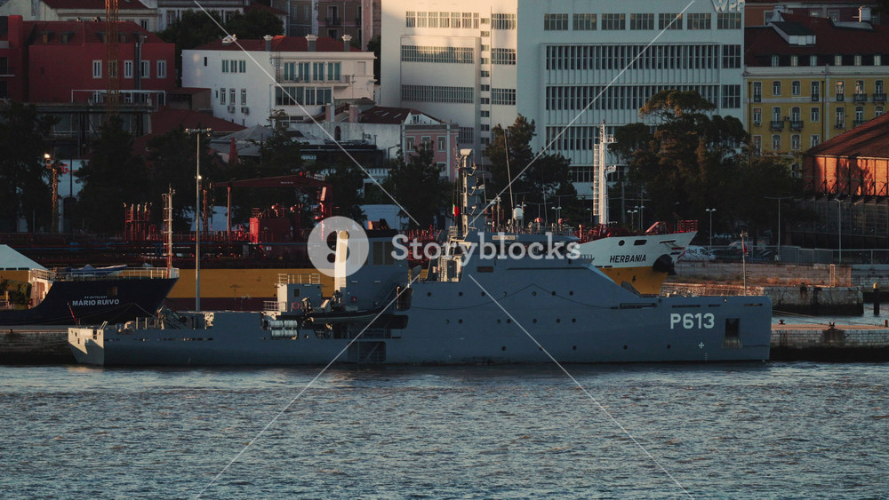16 July 2026 - Lisbon, Portugal - Military patrol vessel P613 docked at harbor with city buildings in the background, showcasing the ship's