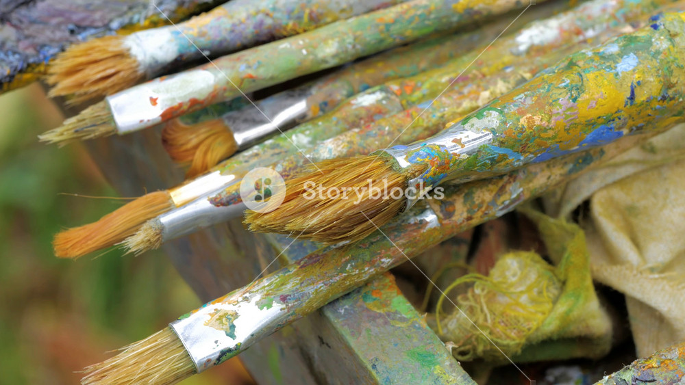 Set of real accessories artist, palette, paints, brushes and palette knife. Artist's palette with oil paints and brushes for painting