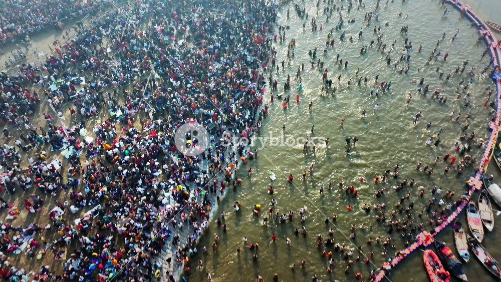 Aerial view of Huge crowd at Triveni Sangam in Prayagraj, India during Maha Kumbh. Kumbh Mela is the most important event, where millions of devotees, including Sadhu take a sacred holy dip in Ganga.