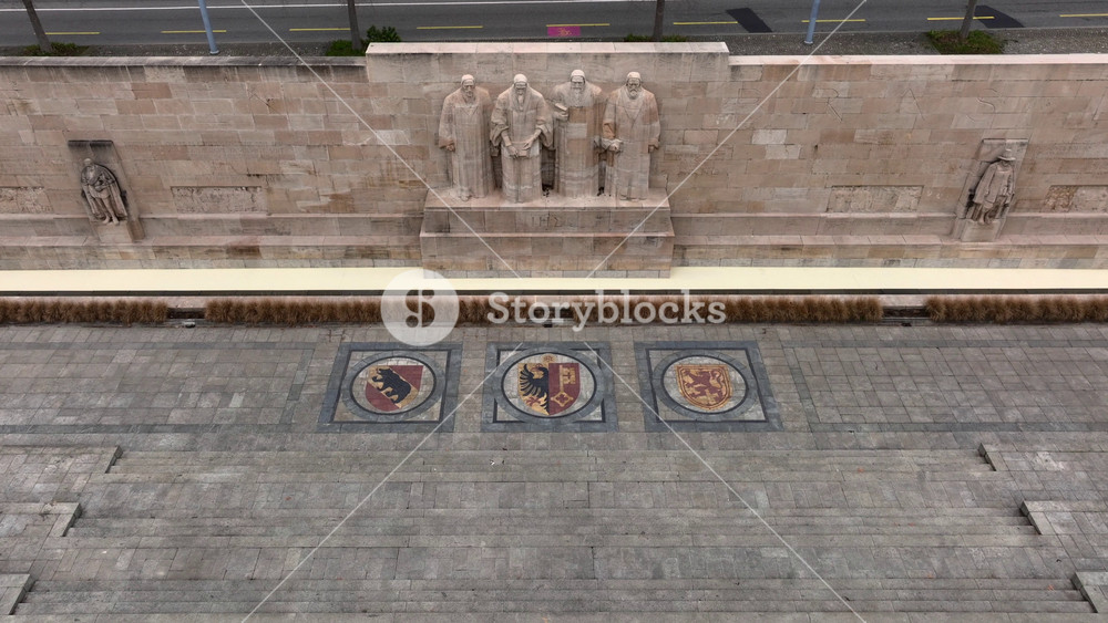 The Reformation Wall in Parc des Bastions in Geneva. towering statues of Protestant leaders. Geneve, Switzerland, Aerial