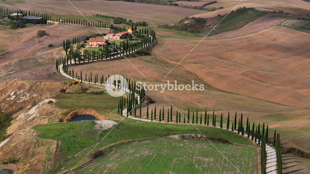 Typical Tuscany Aerial Landscape. Aerial video over amazing Italian Hilly Region. Winding road with cypresses in a day.
