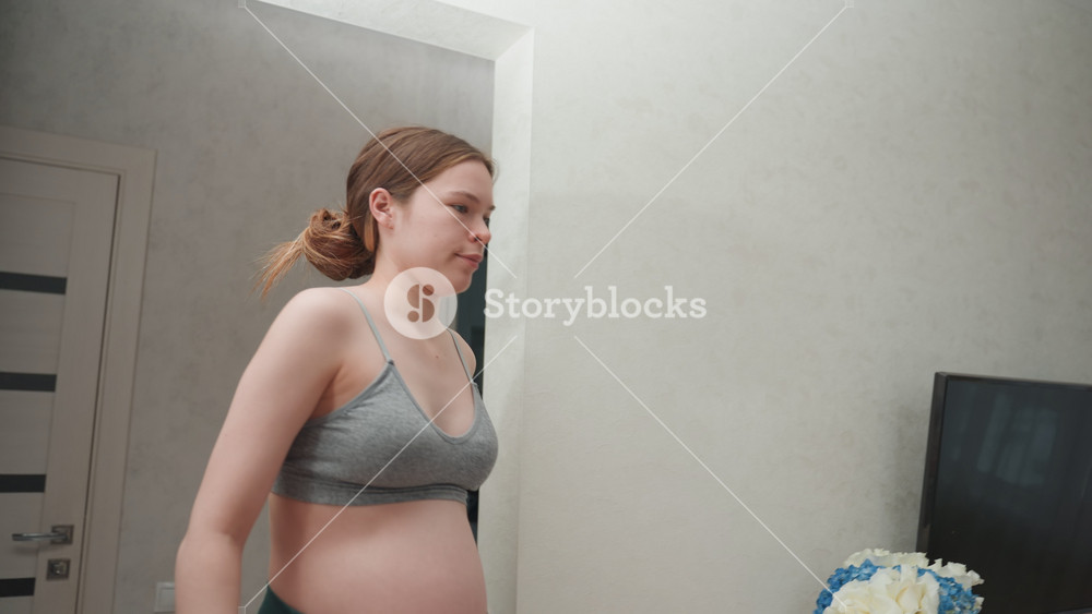 Pregnant woman relaxing. Woman preparing for childbirth peacefully. Expectant female resting calmly near window. Woman who is pregnant