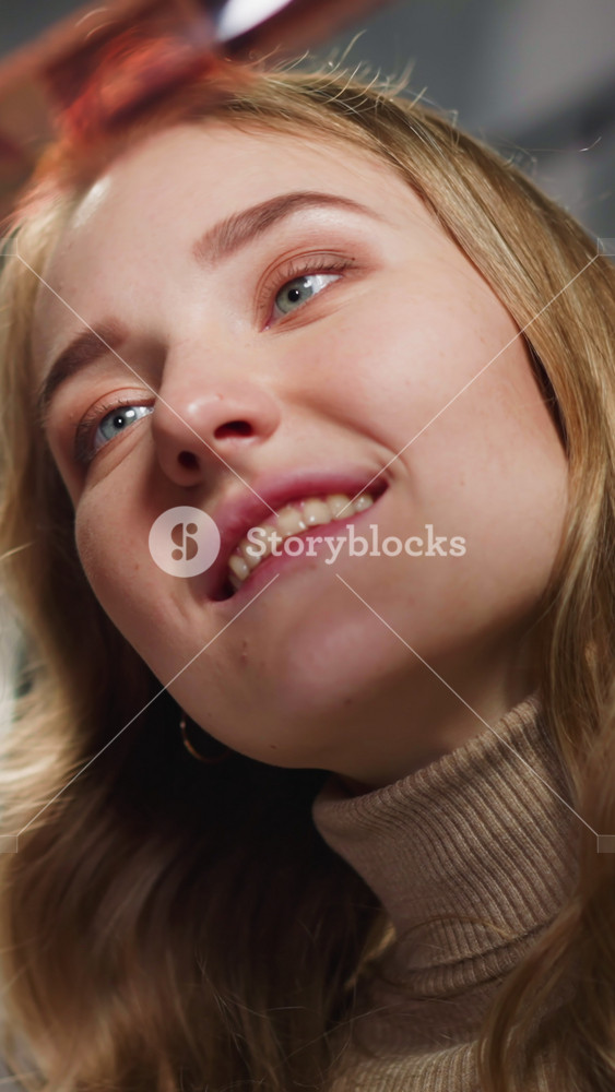 Happy couple of white lady with African-American friend looks at processed coloured film roll with family pictures in studio closeup slow