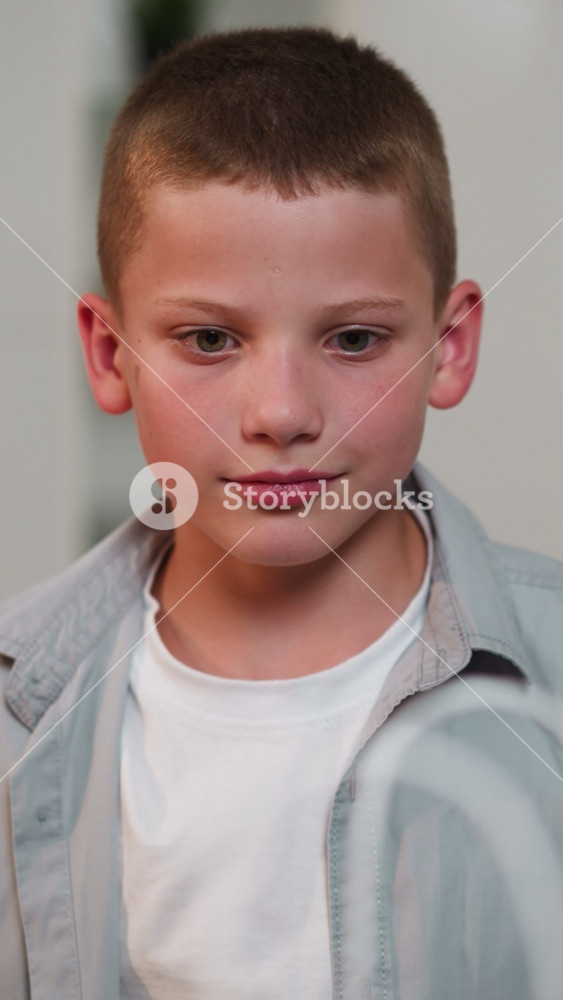 Schoolboy looks at mother expectantly standing in kitchen. Woman takes out food from bag and gives cookies to son. Boy takes treat happily