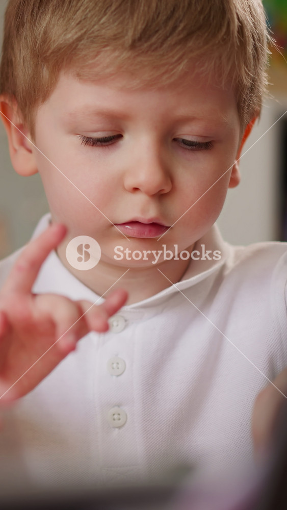 Schoolgirl in back correcting corsage plays short theme on piano to brother at home closeup. Toddler boy looks at sister hand on instrument