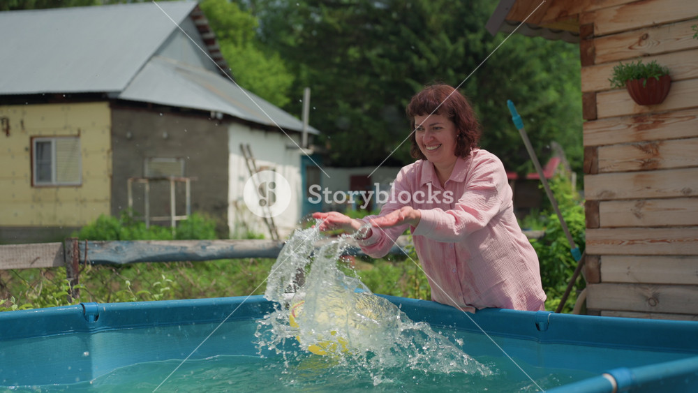 Elder Woman Entertains Child Outdoors, Older Woman Cheerfully Tosses Ball In Sunny Backyard Pool, Elderly Grandmother Engages In Joyful
