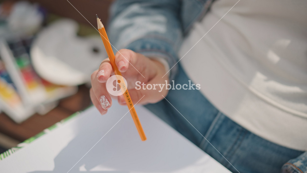 Anticipation builds as artist readies pen and paper. Eager artist prepares to make first mark on blank page. Moment of artistic anticipation