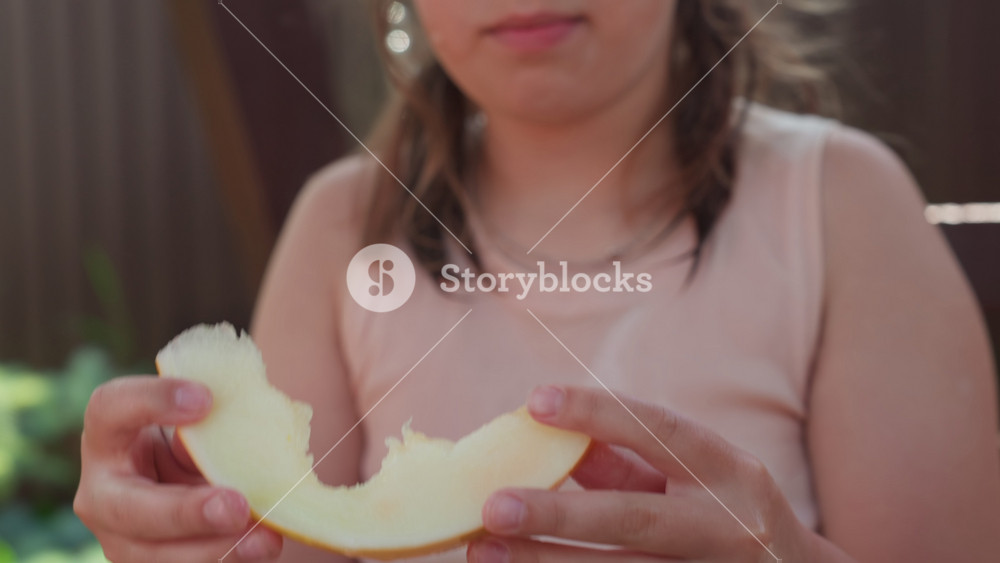 Girl Delights Fresh Fruit, Caucasian Girl Happily Savoring Fruity Summer Snack Outdoors, External Scene Of Young Woman Blissfully Relishing