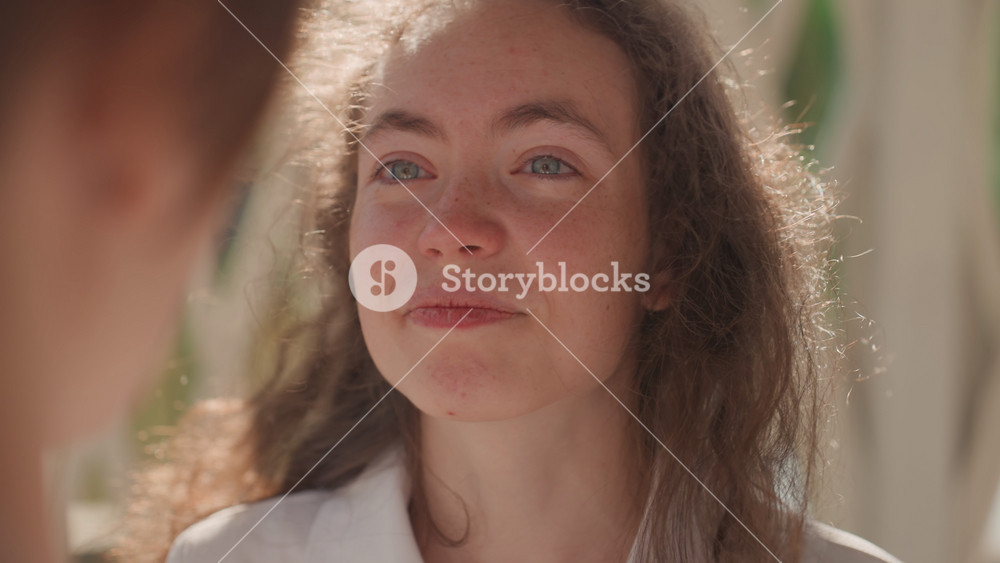 Closeup woman listening to partners words. Imagined teacher role absorbs a tearful, hopeful promise about family and future, soft backlight