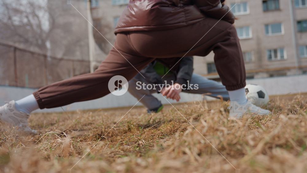 closeup of player stretching amid urban setting, action photo capturing player lunging in gritty city setting, vivid shot of sportsman