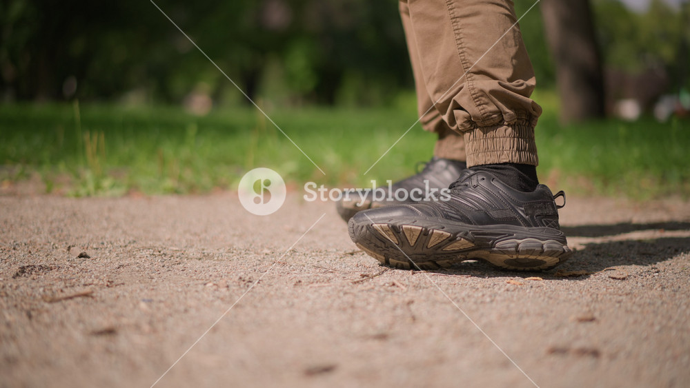 Sneakers With Deliberate Steps, Close View Of Sports Shoes On Sandy Ground Showing Precise Foot Positioning, Detailed Image Of Athletic