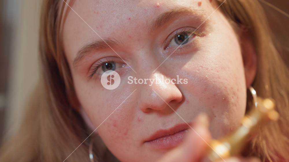 Closeup caucasian woman holding queen piece in cozy cafe corner, contemplative chess player, freckles and hoop earrings, warm bokeh lights